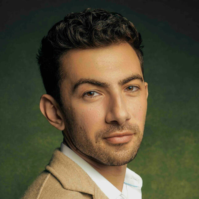 Musician John Dimase Headshot wearing a white collared shirt and Beige Jacket.